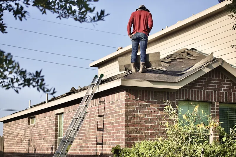 Professional roofer working on a residential roof in Callaway